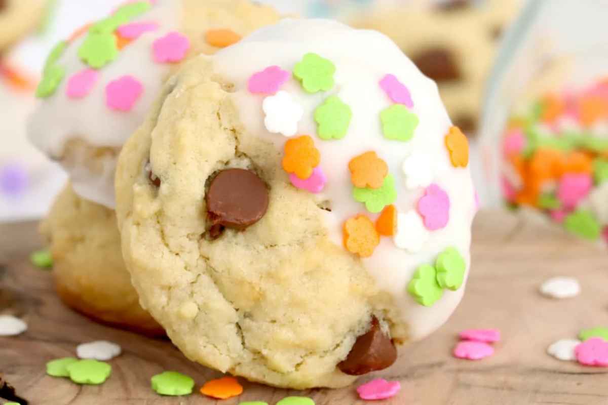 Easter chocolate chip cookies with white icing and colorful sprinkles.