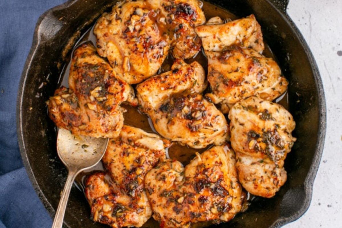 A pan of chicken with a fork for dinner recipes.