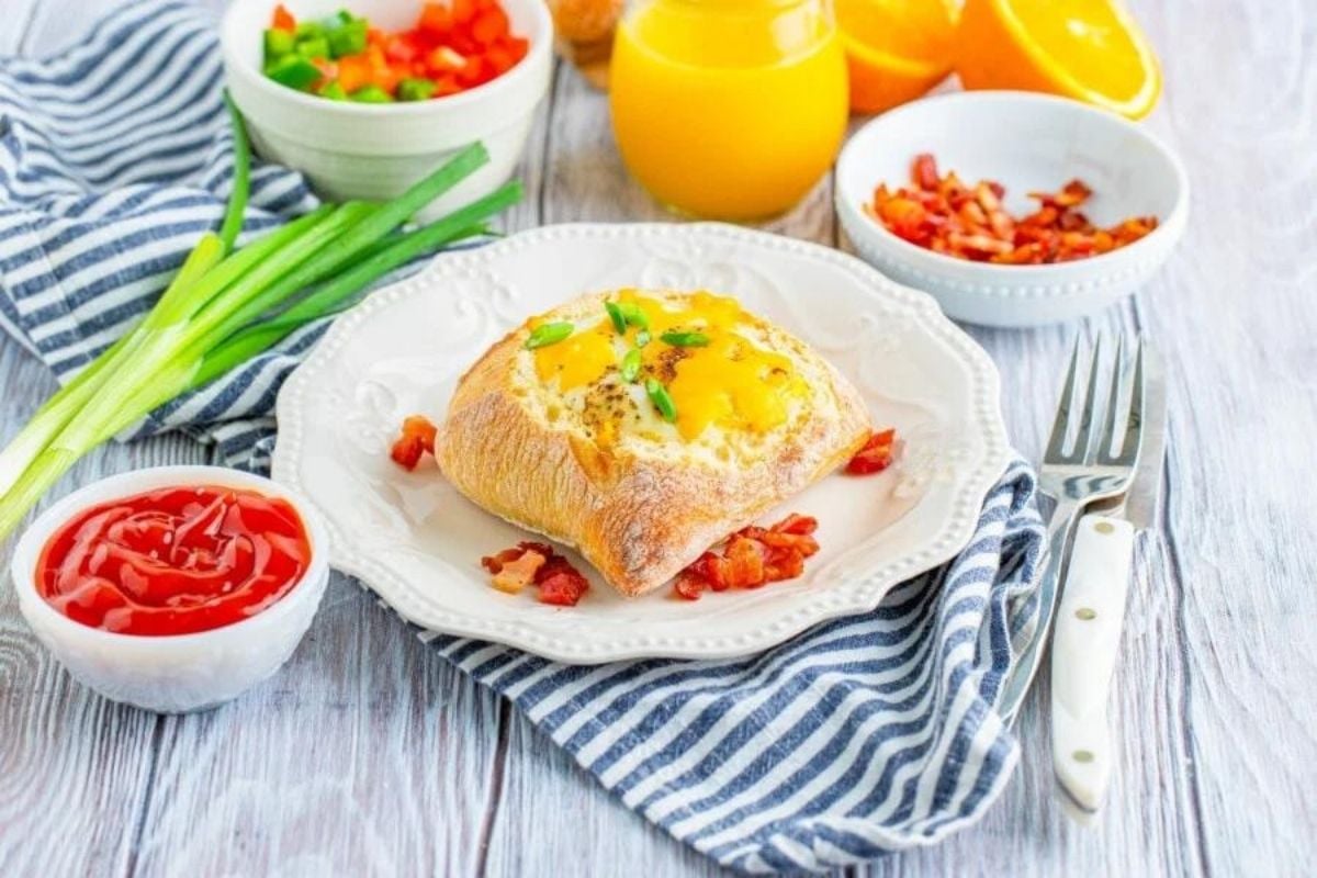 A Father's Day breakfast setting featuring a poached egg on toast, garnished with herbs, accompanied by diced vegetables, ketchup, and orange juice.