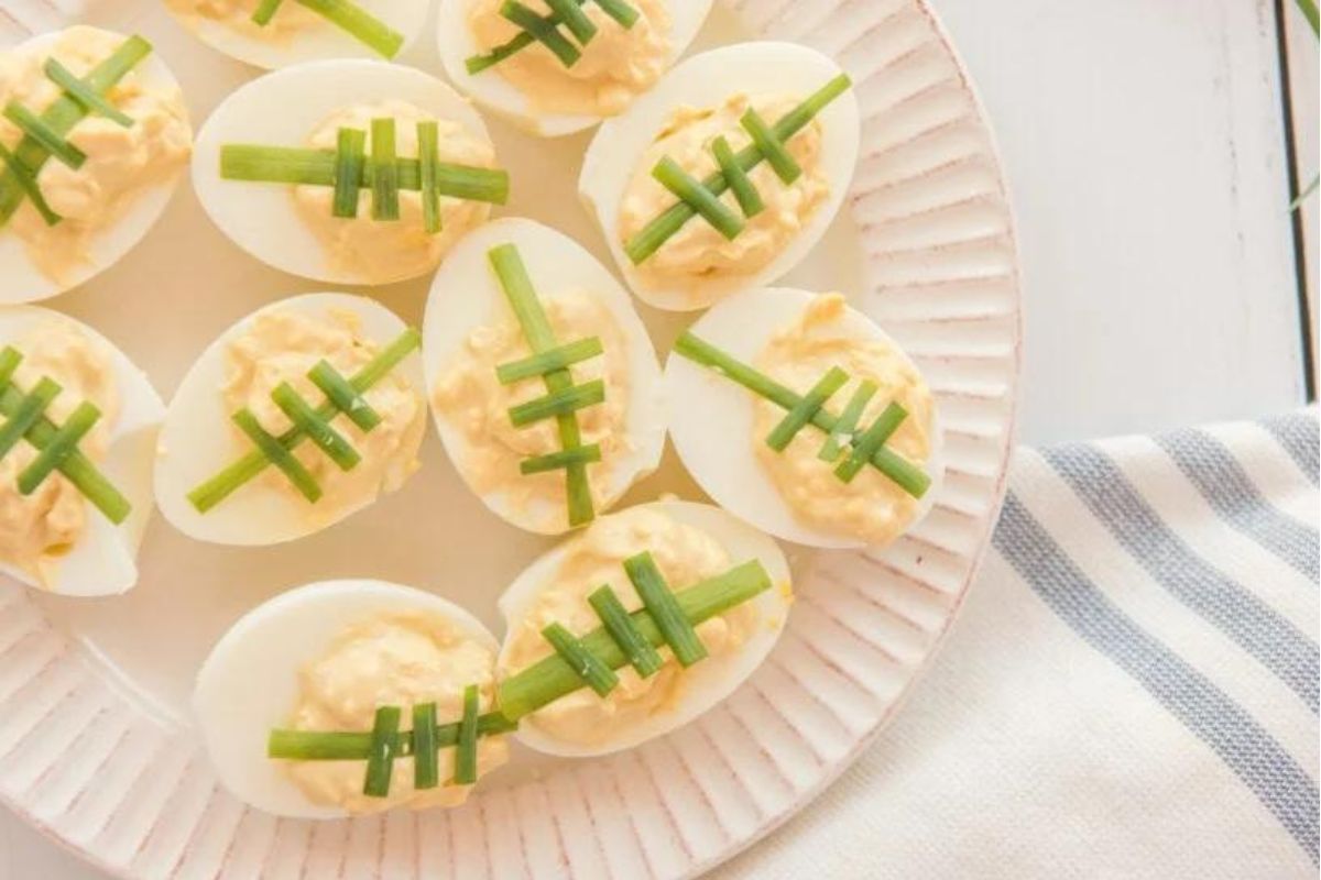 Deviled egg recipes with footballs on a plate.