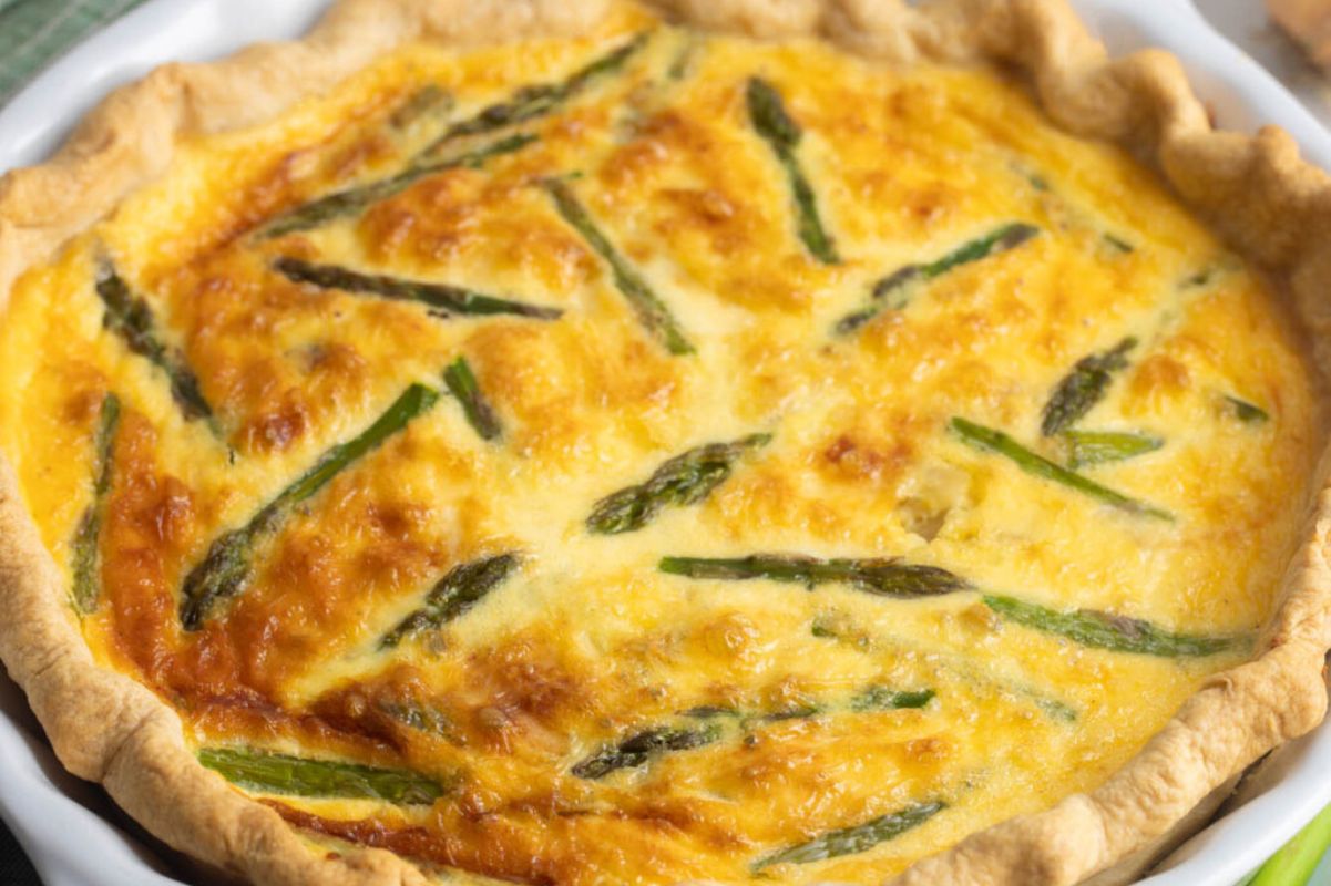 An Easter sides freshly baked asparagus quiche in a pie crust.