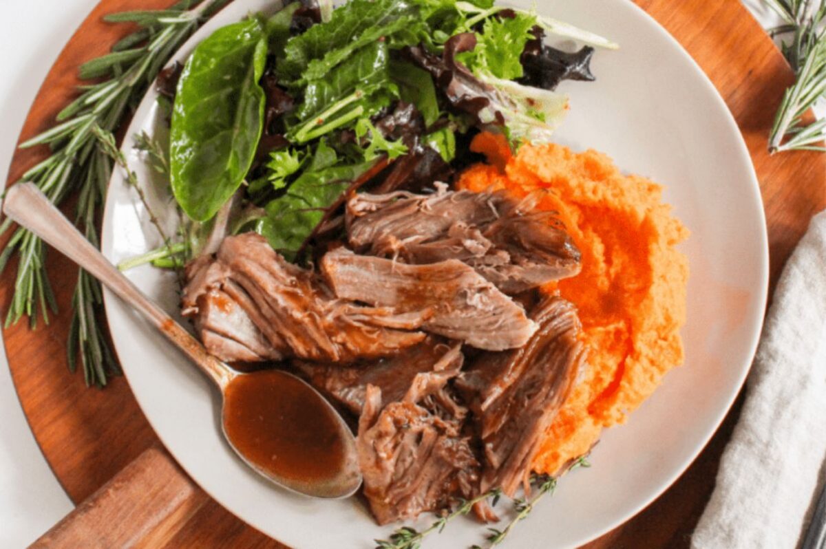 Easter dinner: Roasted meat served with mashed sweet potatoes and a side of mixed greens.