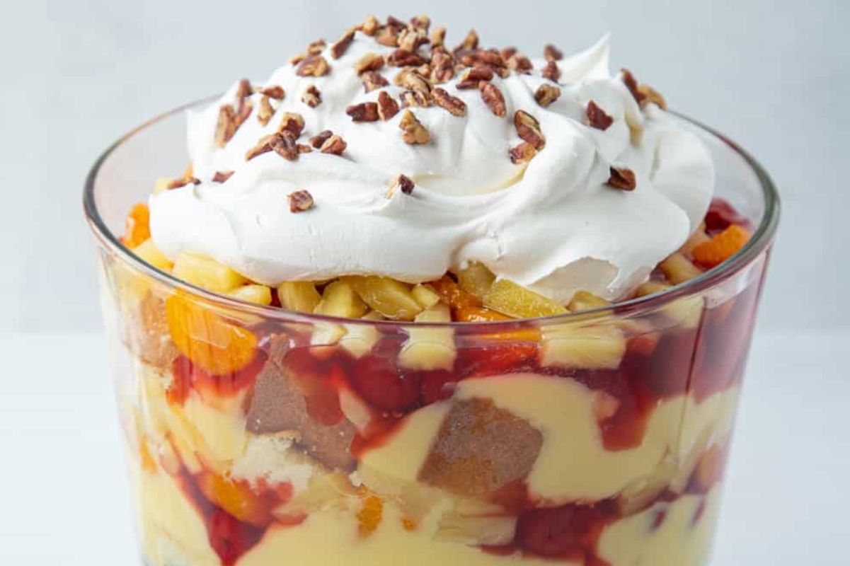 Easter desserts: Layered fruit trifle with whipped cream topping and chopped nuts.