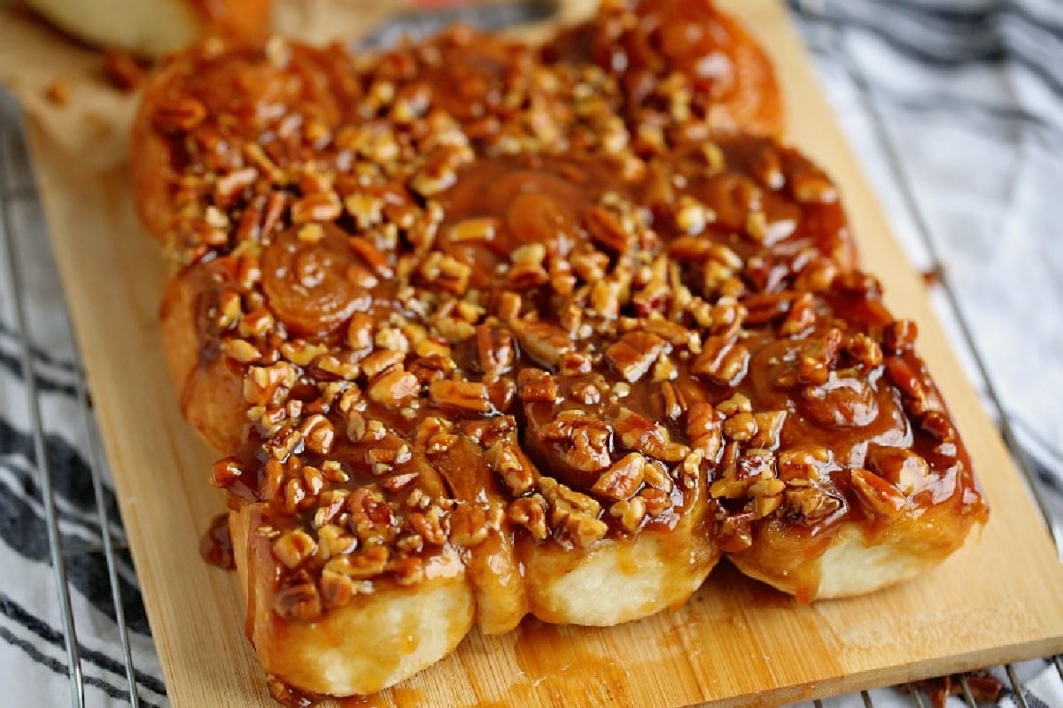 Old School Recipes: Caramel pecan rolls on a wooden board.
