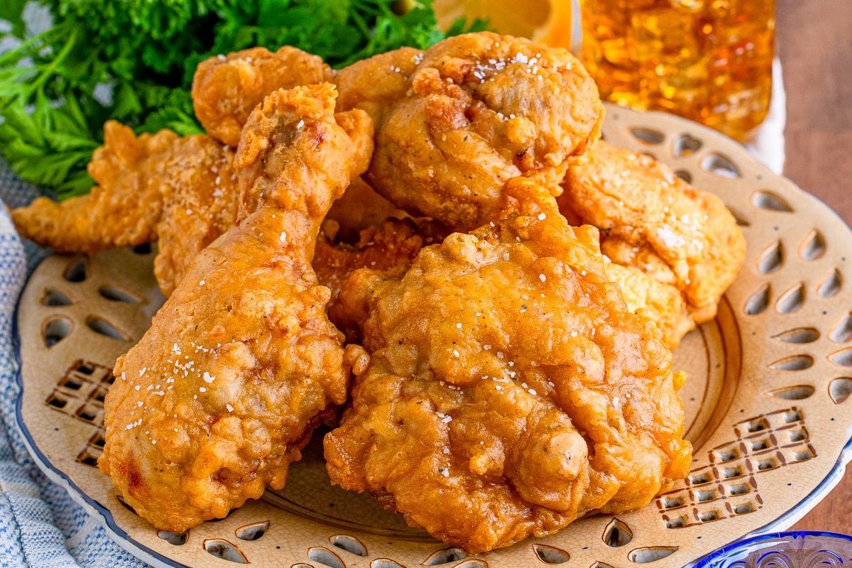 A plate of golden-brown fried chicken pieces garnished with parsley.