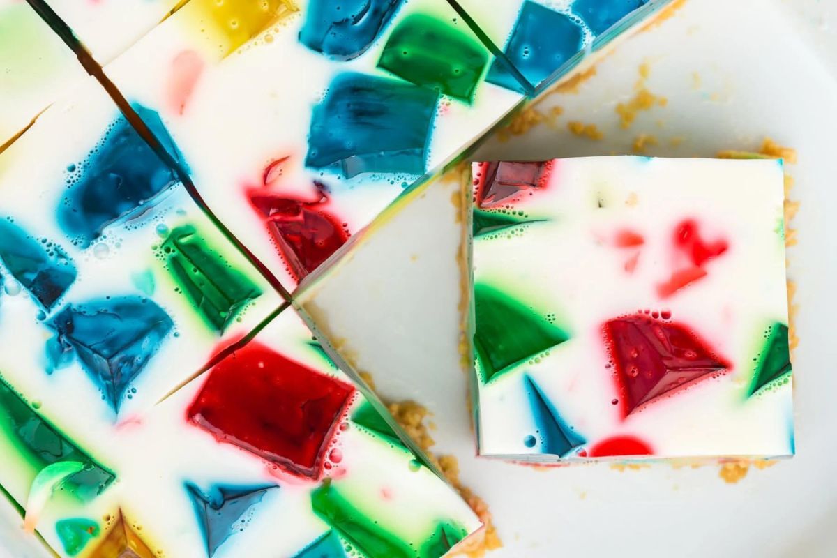 Slices of colorful stained glass Jello recipes on a plate.