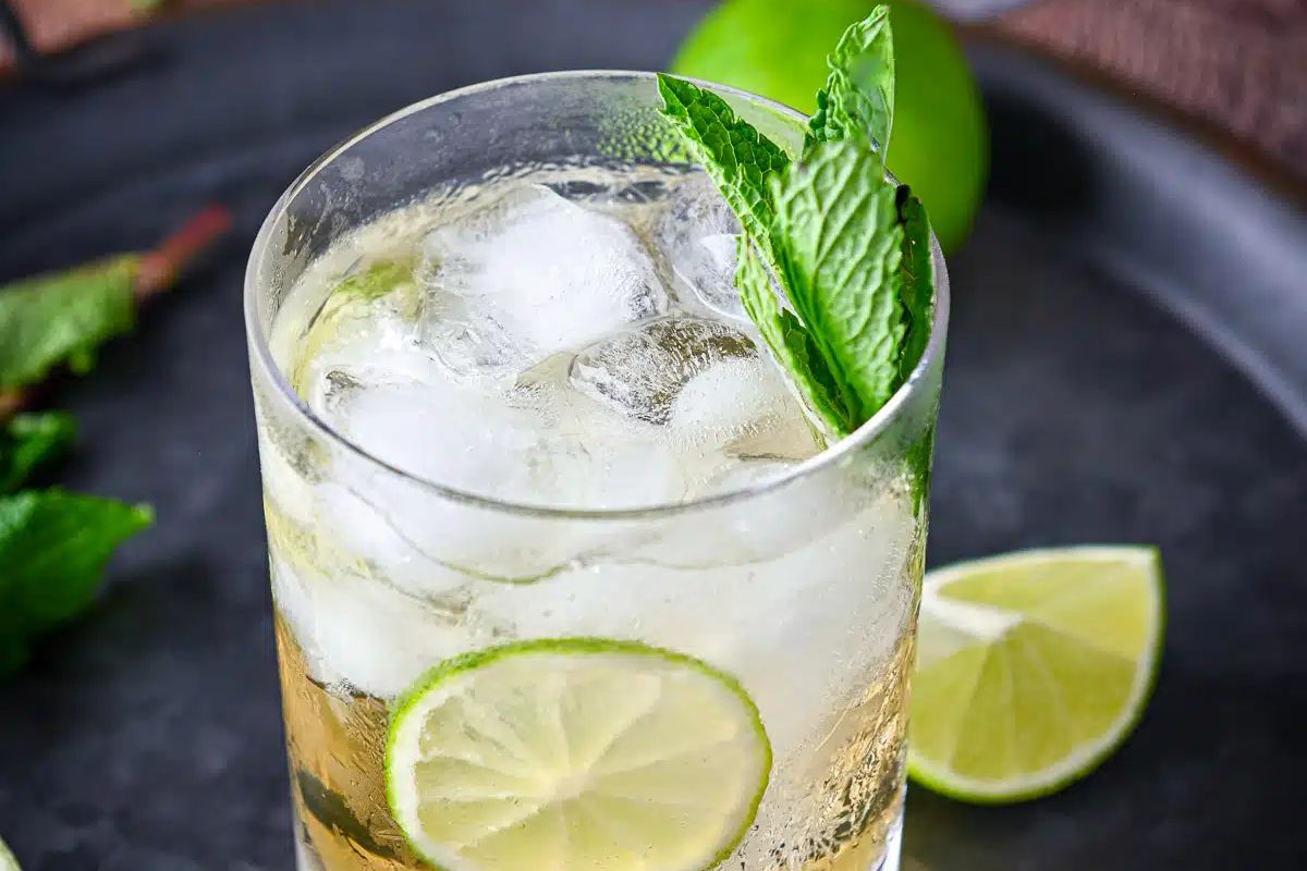 A glass of Easter cocktails garnished with lime slices and mint leaves.