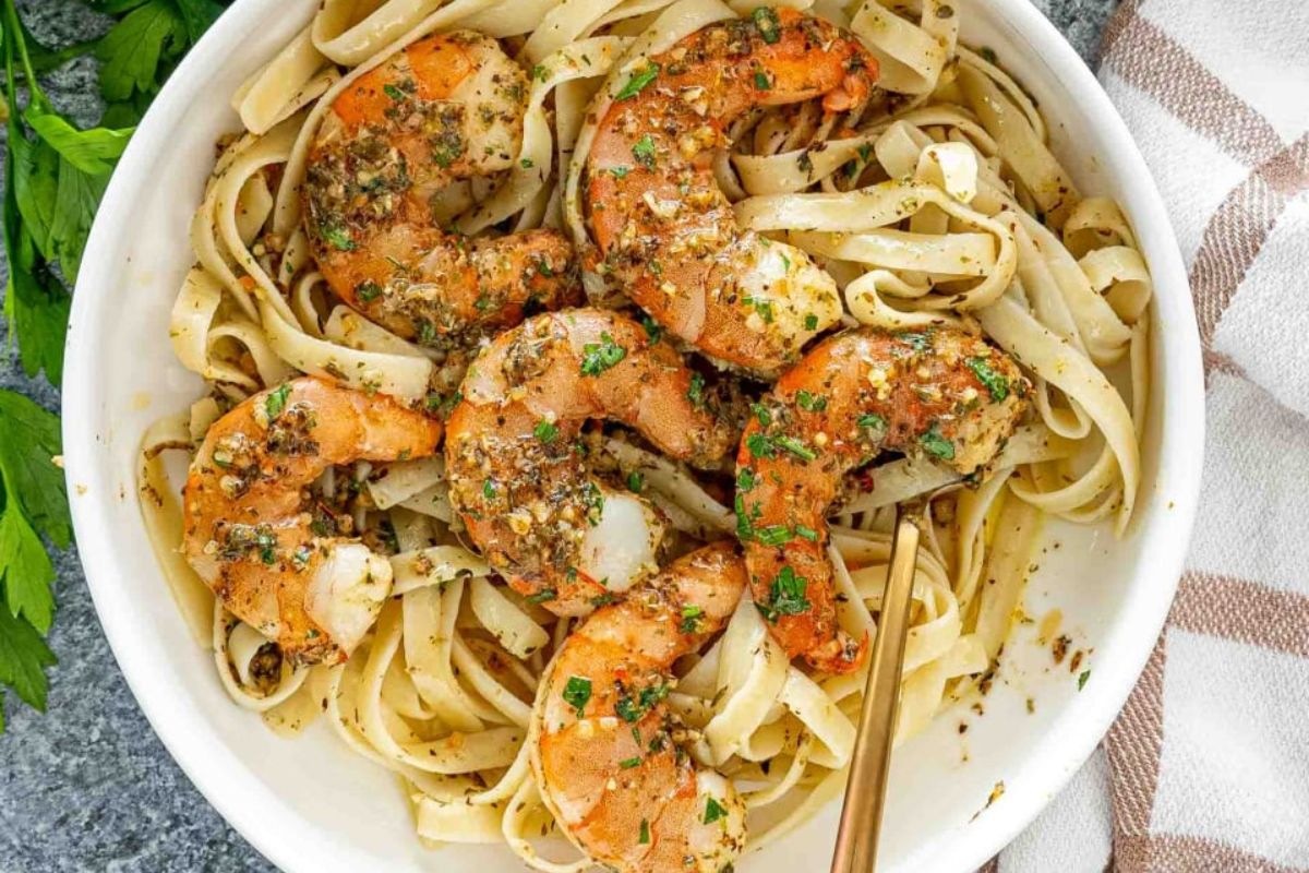 A bowl of pasta with seasoned shrimp on top, perfect for Easter dinner.