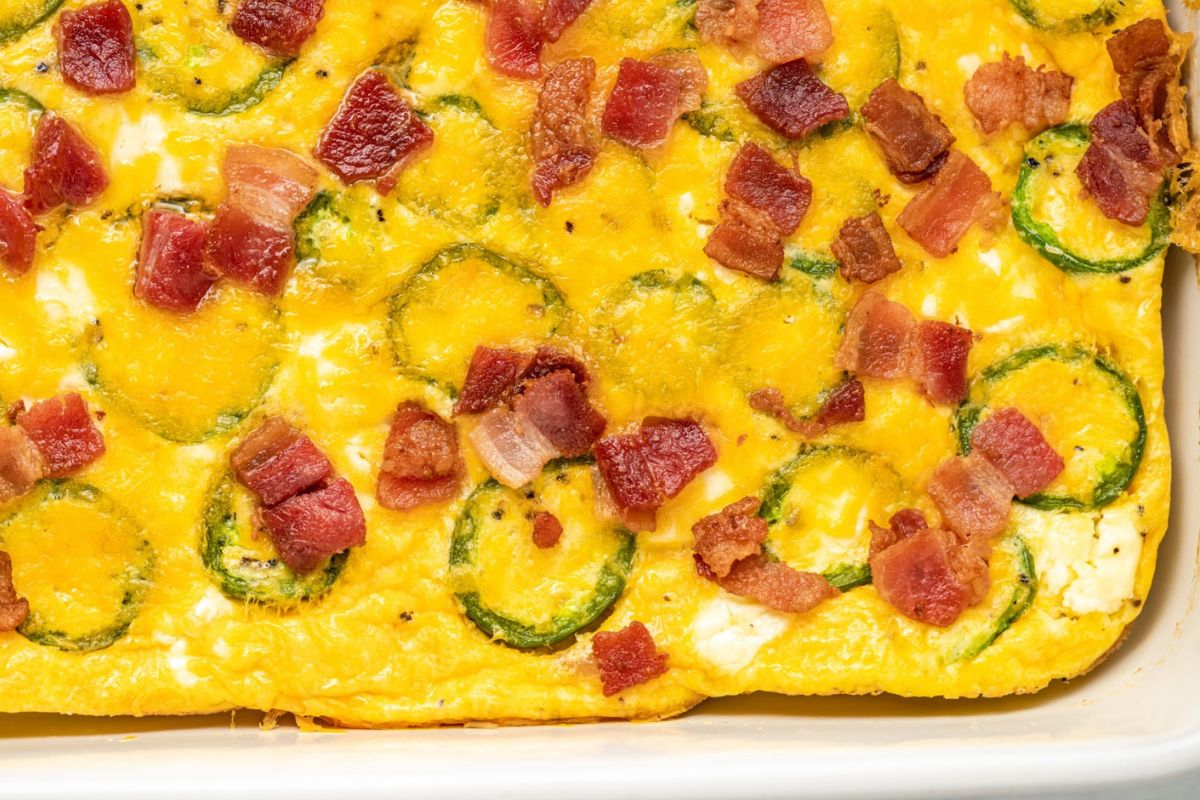Bacon and jalapeno egg quiche in a white baking dish.