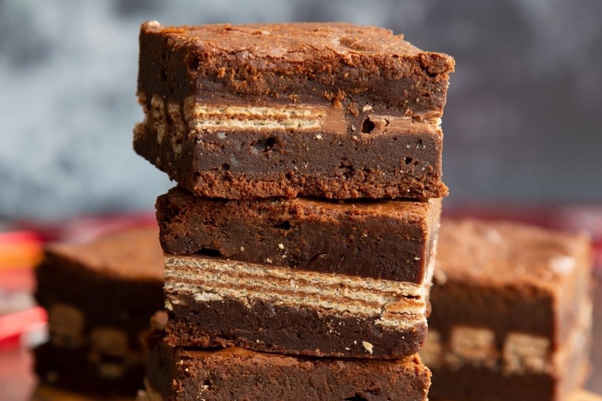 A stack of chocolate brownies, perfect for potluck desserts, stacked on top of each other.
