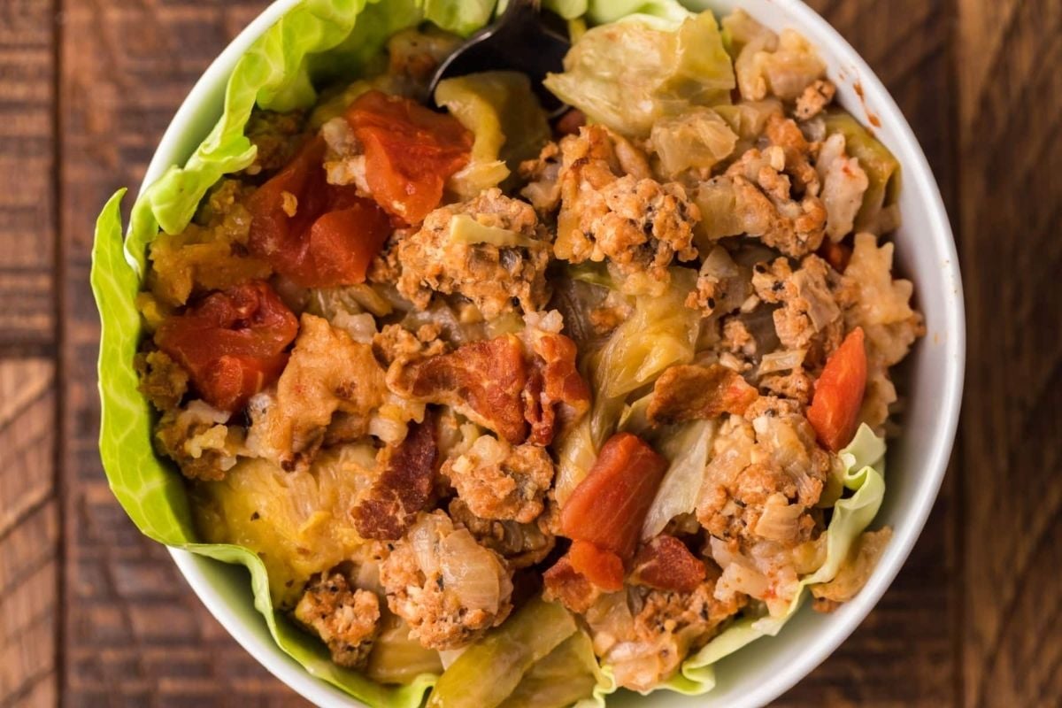 A white bowl filled with lettuce and meat from slow cooker recipes.