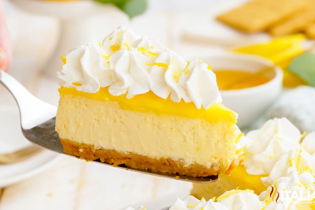 An Easter dessert consisting of a slice of lemon cheesecake topped with whipped cream and lemon zest, served with honey on the side.