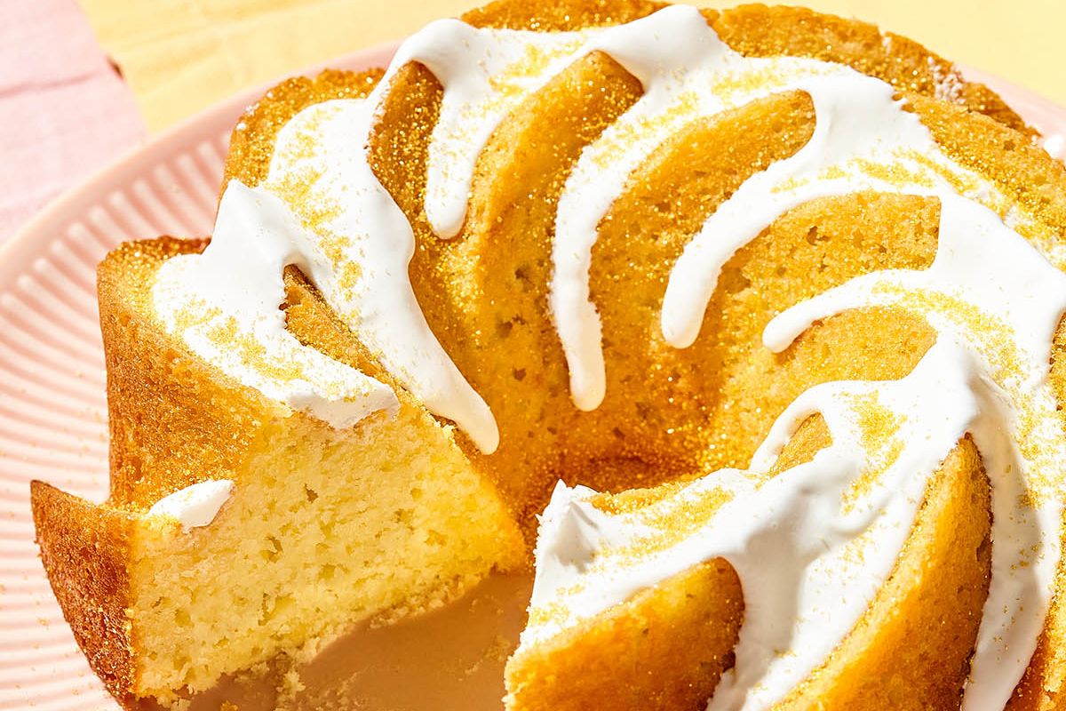 Sliced Easter bundt cake with white glaze on a pink plate.