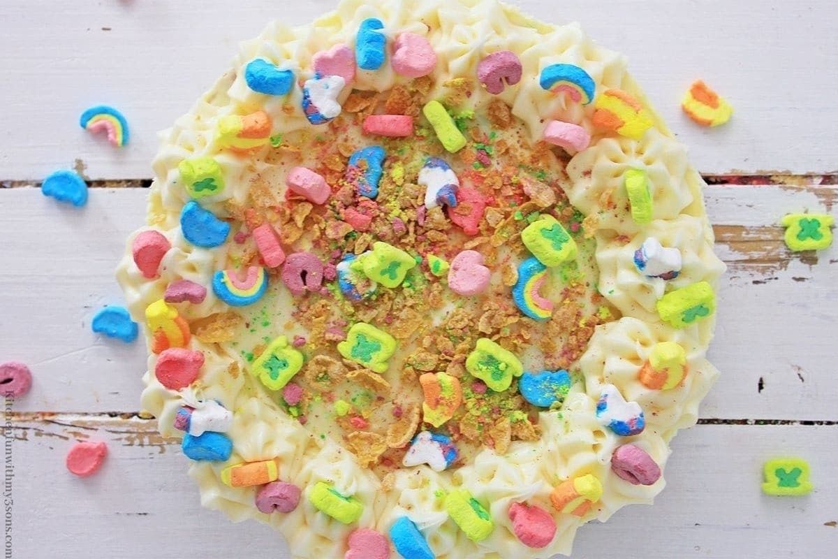 A cake topped with marshmallows, graham crackers, and recipes using Lucky Charms.