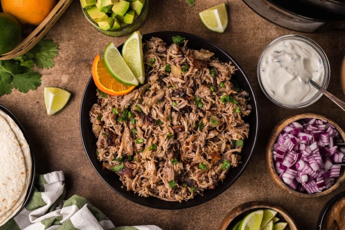 A plate of food with different bowls of slow cooker recipes.