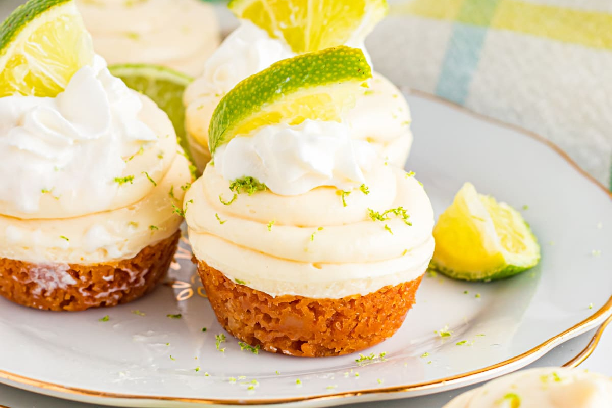 A plate of lime cupcakes topped with cream and lime zest, inspired by pie recipes.