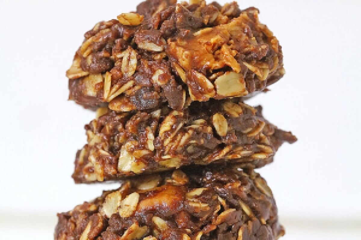 A stack of three homemade, old fashioned oatmeal chocolate chip cookies.