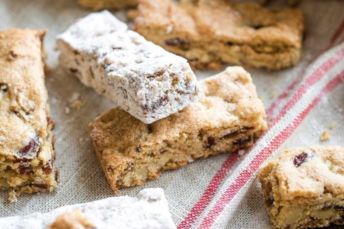 A stack of cookies with powdered sugar on top, perfect for potluck desserts.