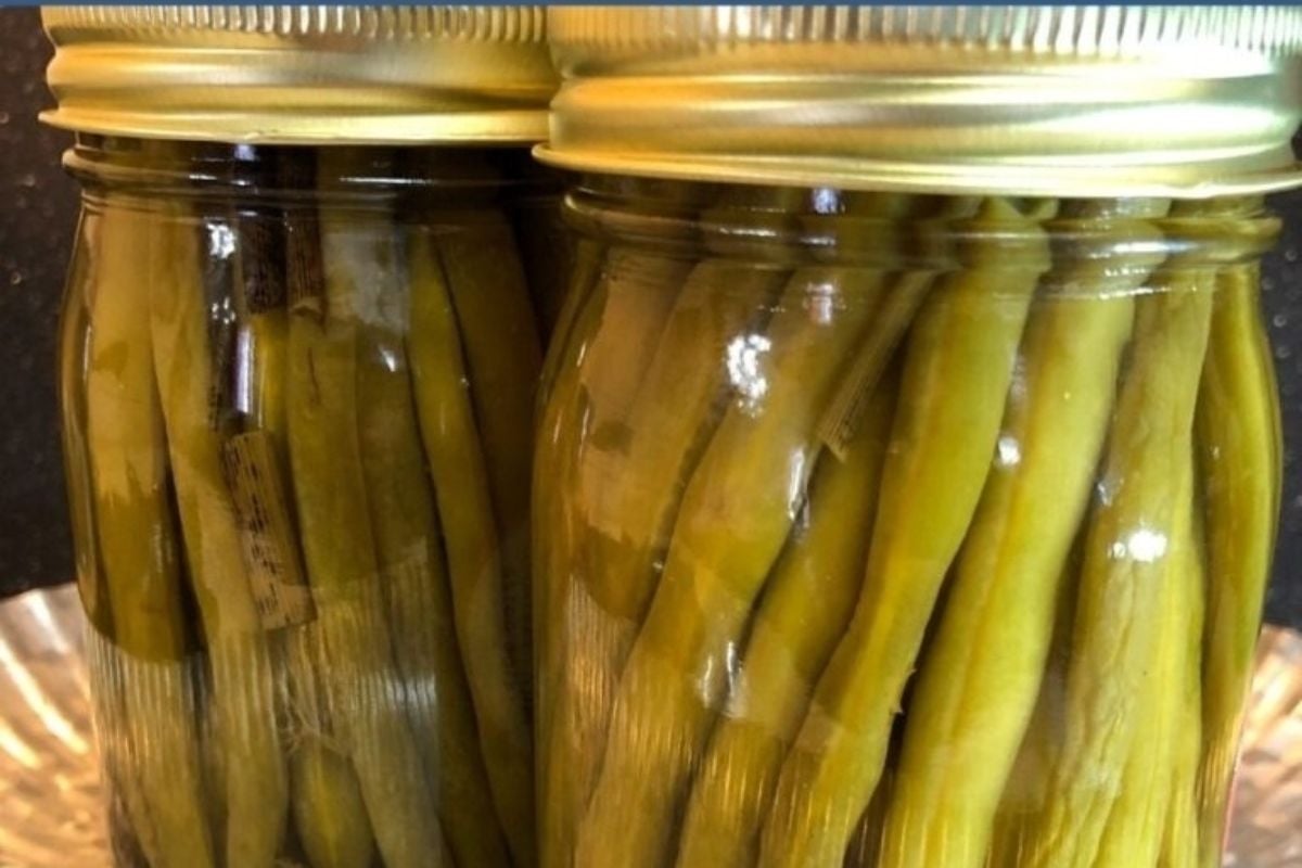 Jars of pickled green bean recipes on display.