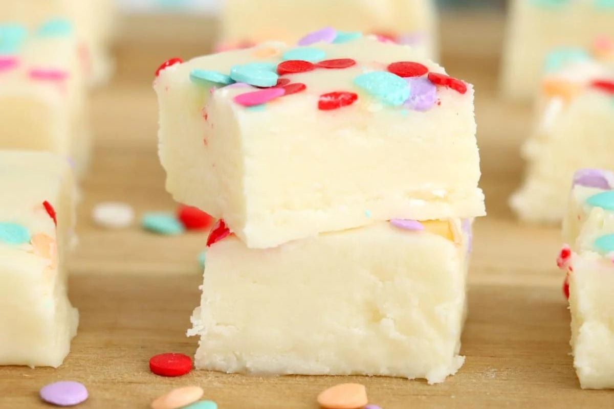 A stack of vanilla fudge squares topped with colorful sprinkles, inspired by potato recipes.