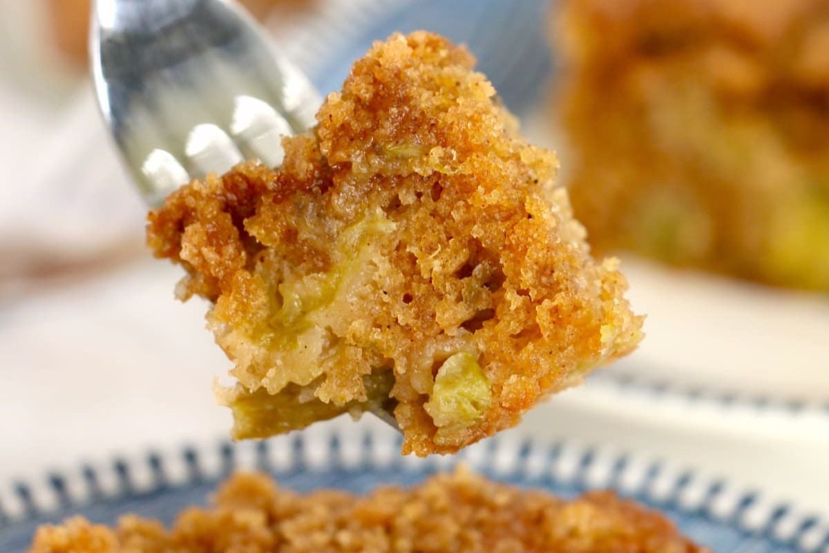 Close-up of a breaded fried rhubarb bite on a fork.