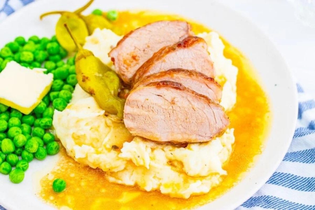 A plate of food with slow cooker recipes meat and mashed potatoes.