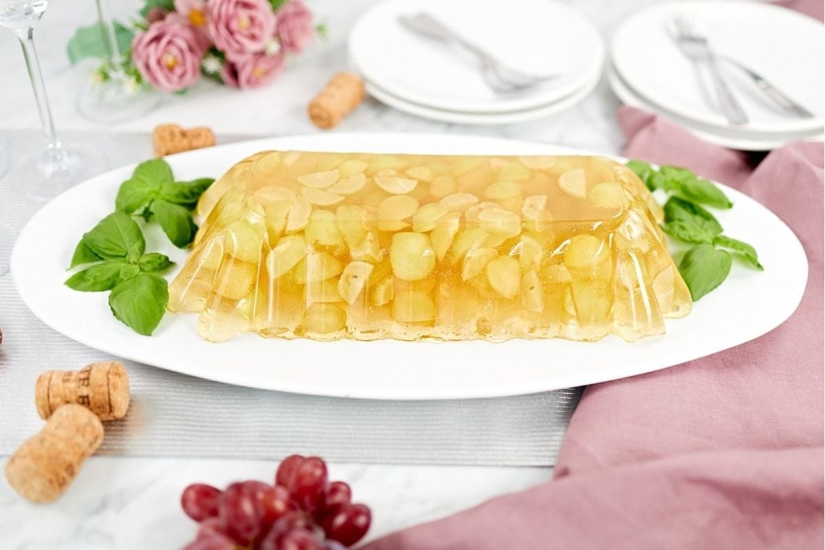 A plate with a grape jello salad on it.