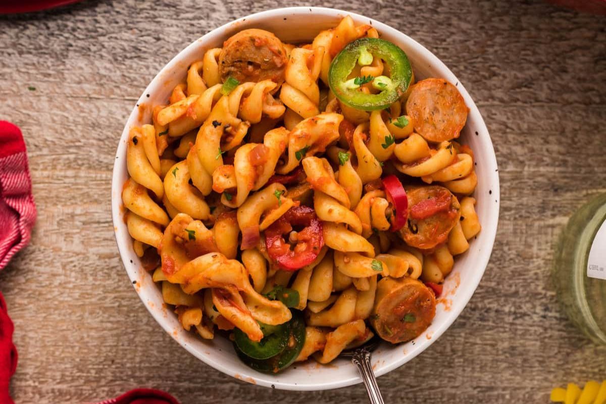 A bowl of pasta with peppers and sausage from our dinner recipes.