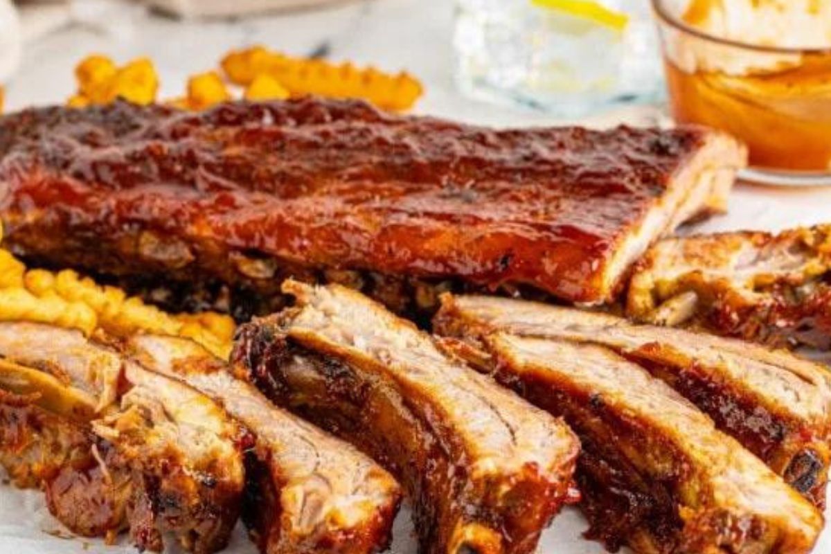 Easy Rib Recipes: Sliced barbecue pork ribs served with a side of corn.