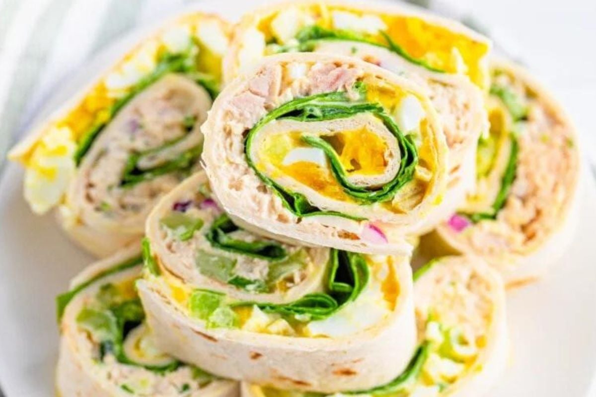 Turkey and egg pinwheel wrap slices with lettuce on a plate.