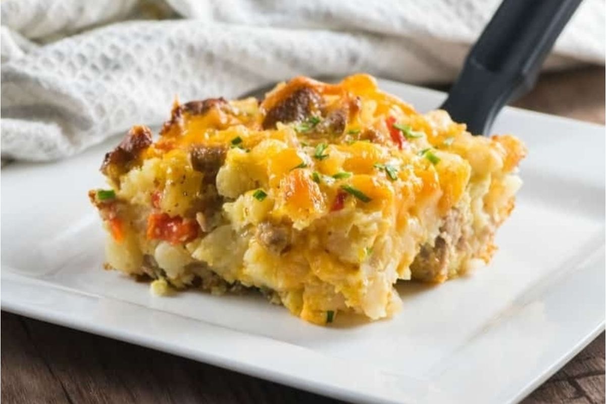 Breakfast spring casserole on a white plate with a fork.