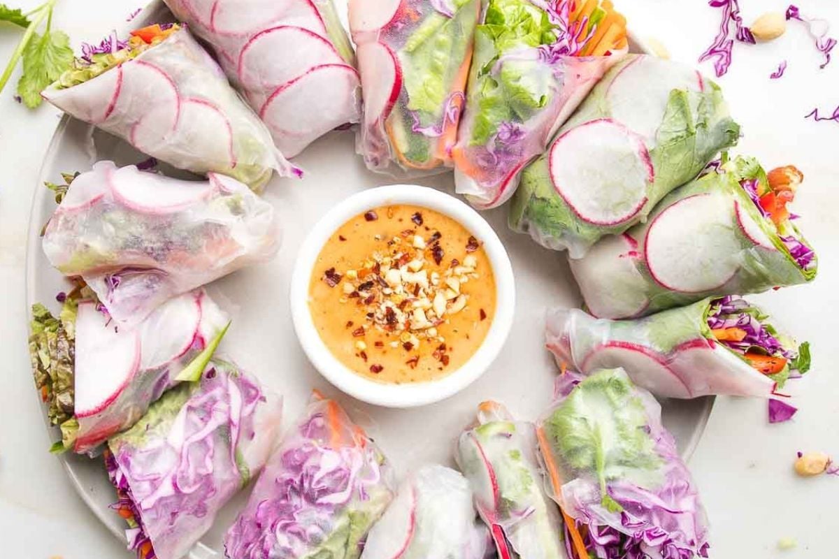 An Easter appetizer of fresh spring rolls filled with vegetables served with peanut dipping sauce.