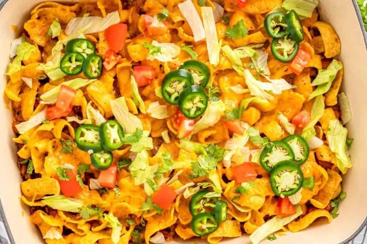 Nachos in a casserole dish with pizza flavored tomatoes and jalapenos.