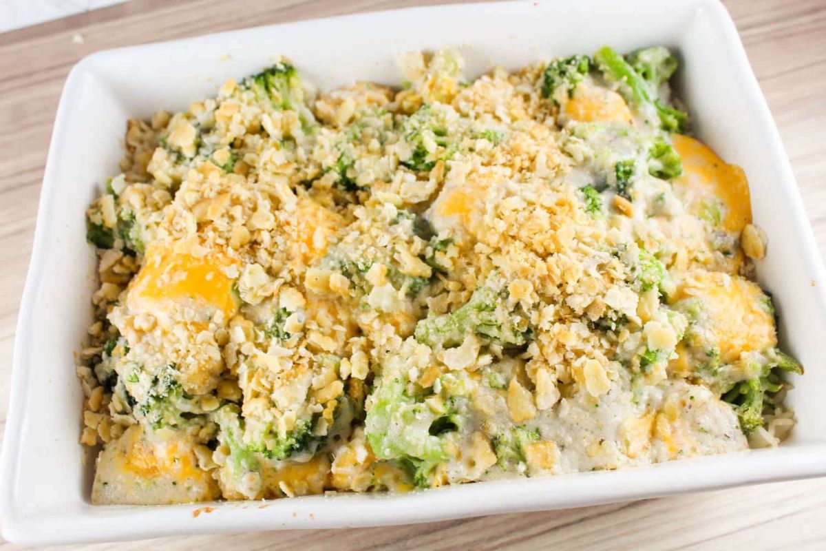 A baked broccoli casserole made with a can of cream soup, topped with breadcrumbs and melted cheese in a white rectangular dish.