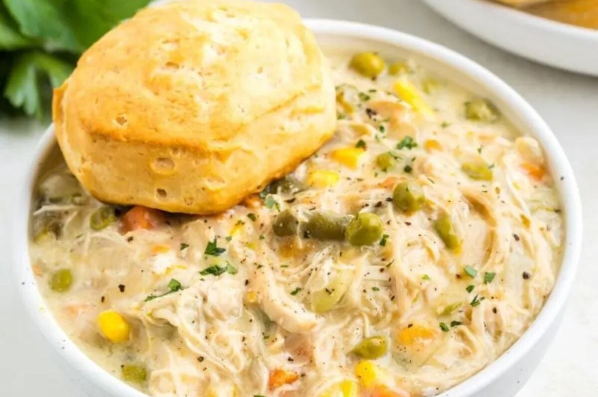 A bowl of soup made using frozen vegetables, with a biscuit on top.