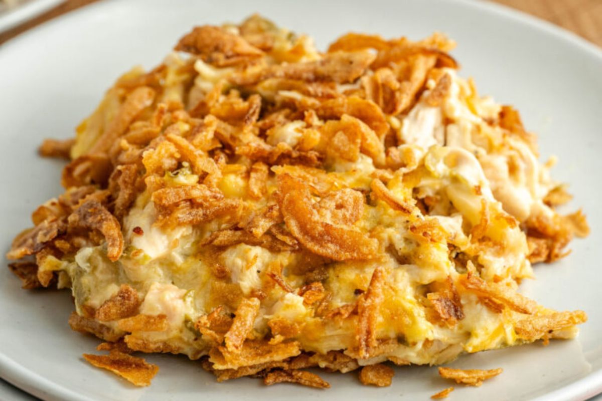 A plate of tuna noodle casserole made with a can of cream soup, topped with crispy fried onions.