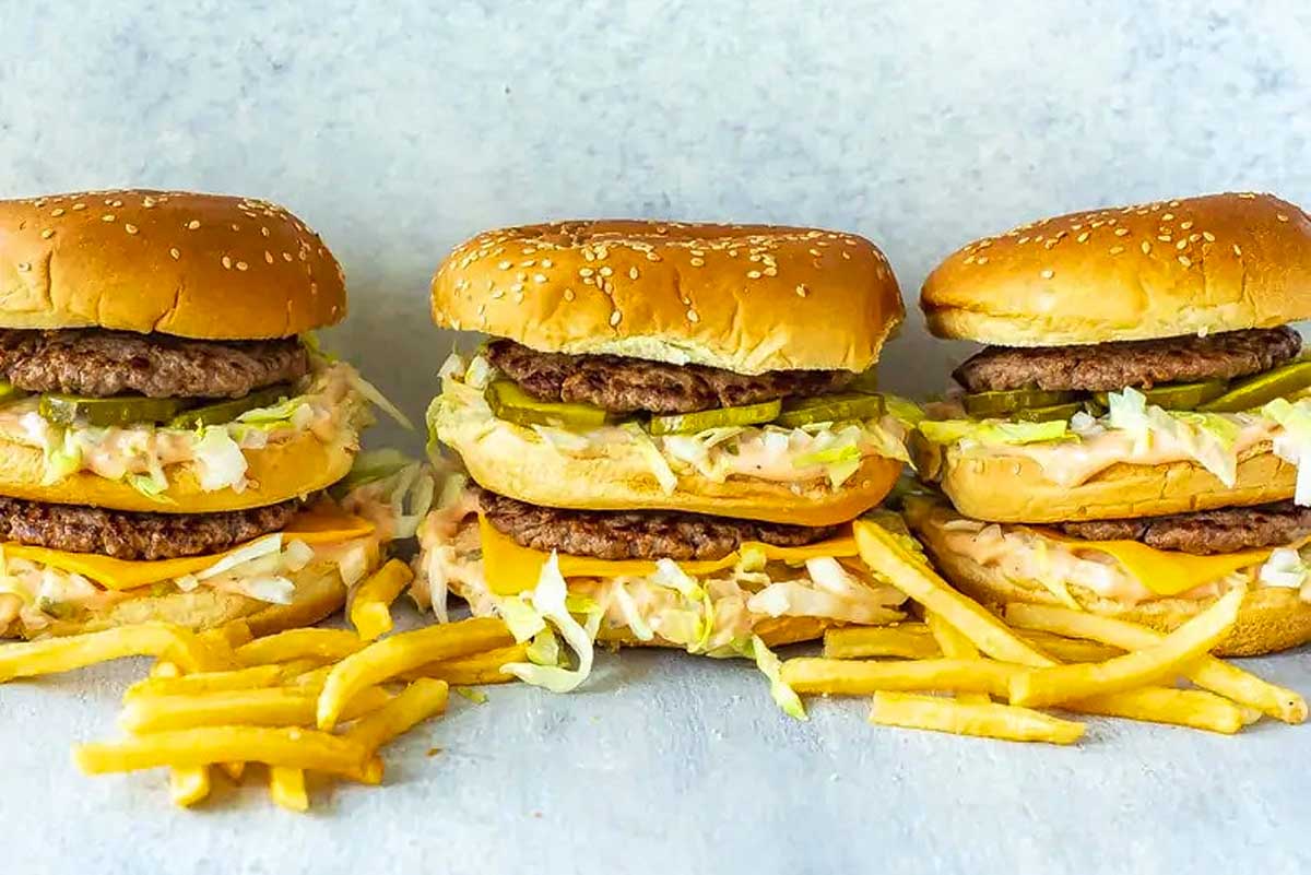 Three McDonald's cheeseburgers with a side of fries.