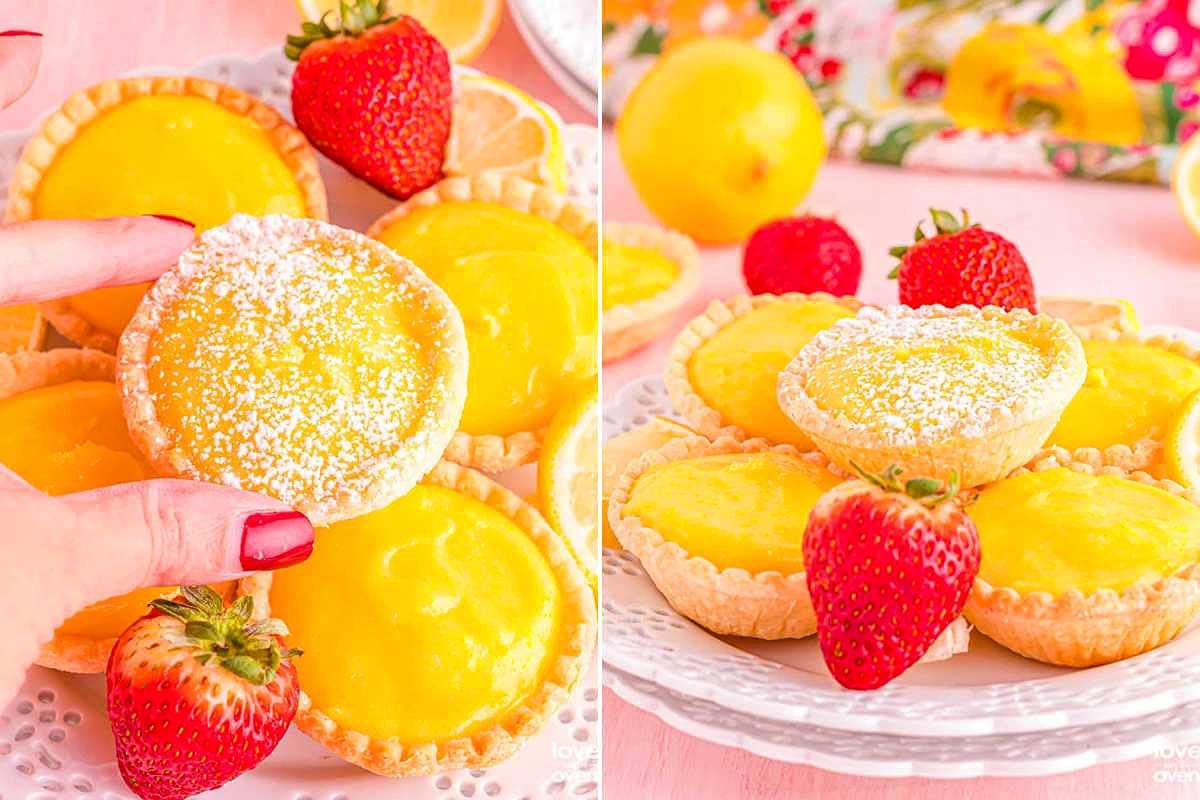 A person holding a lemon tart topped with powdered sugar alongside a plate of assorted lemon and strawberry tarts for a church potluck.