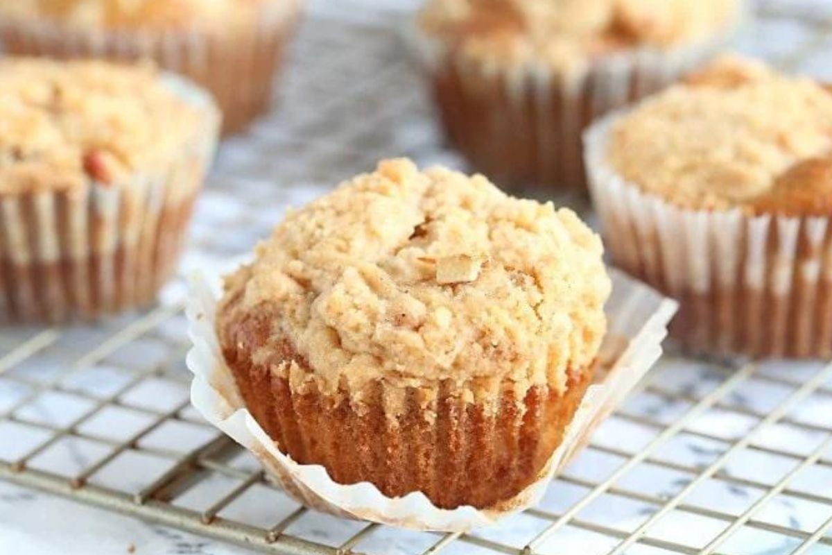 Freshly baked caramel muffins cooling on a wire rack, with a focus on one muffin in the foreground.