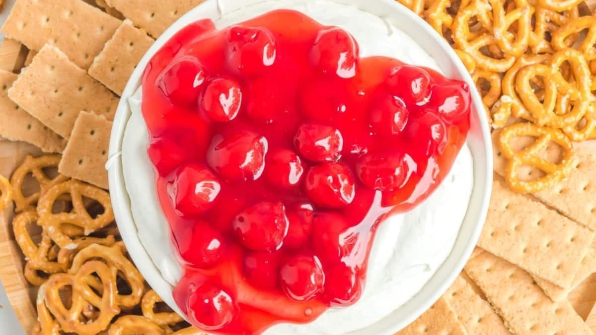 Creamy Cherry Cheesecake Dip surrounded by crackers and pretzels.