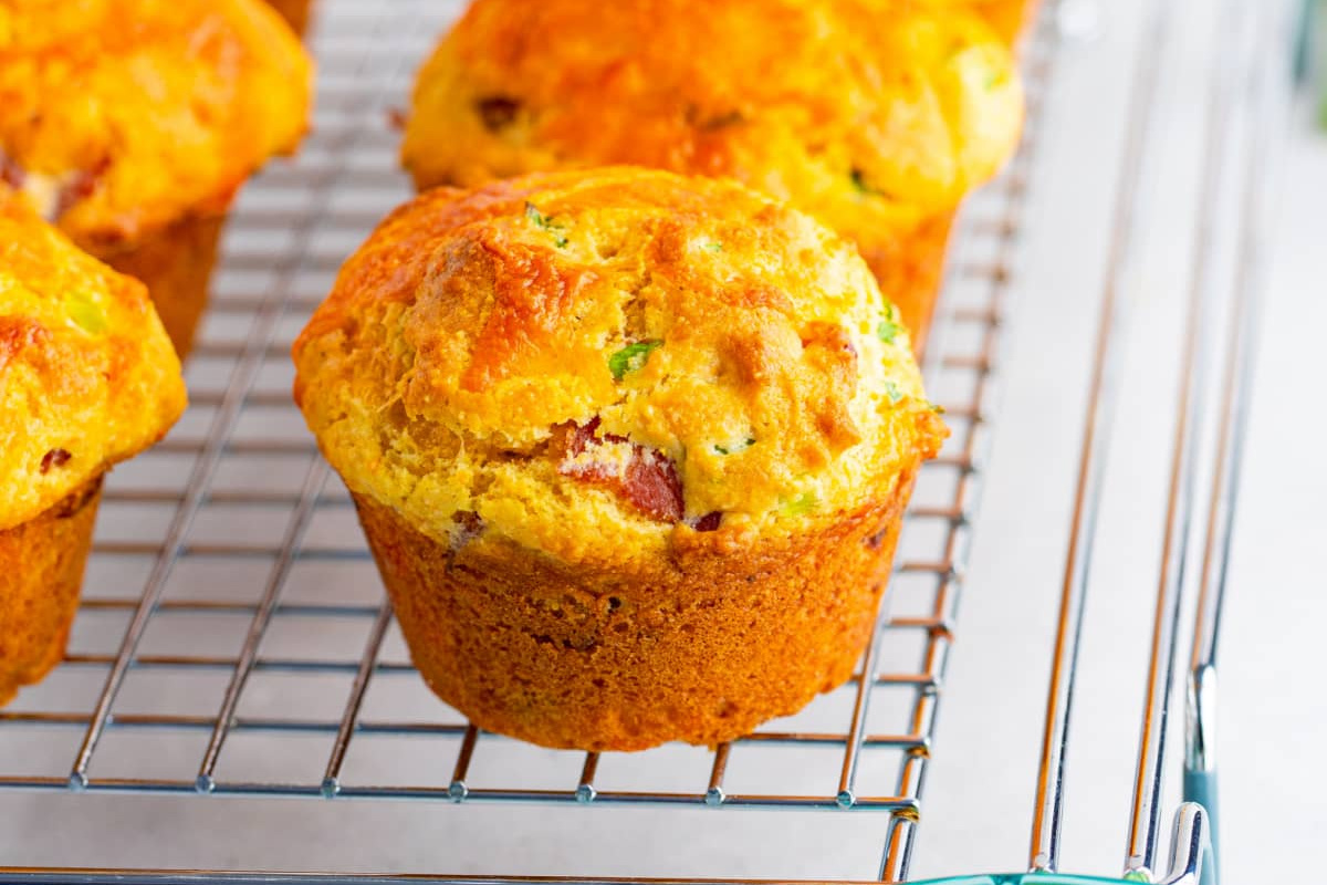 A corn muffin on a cooling rack.