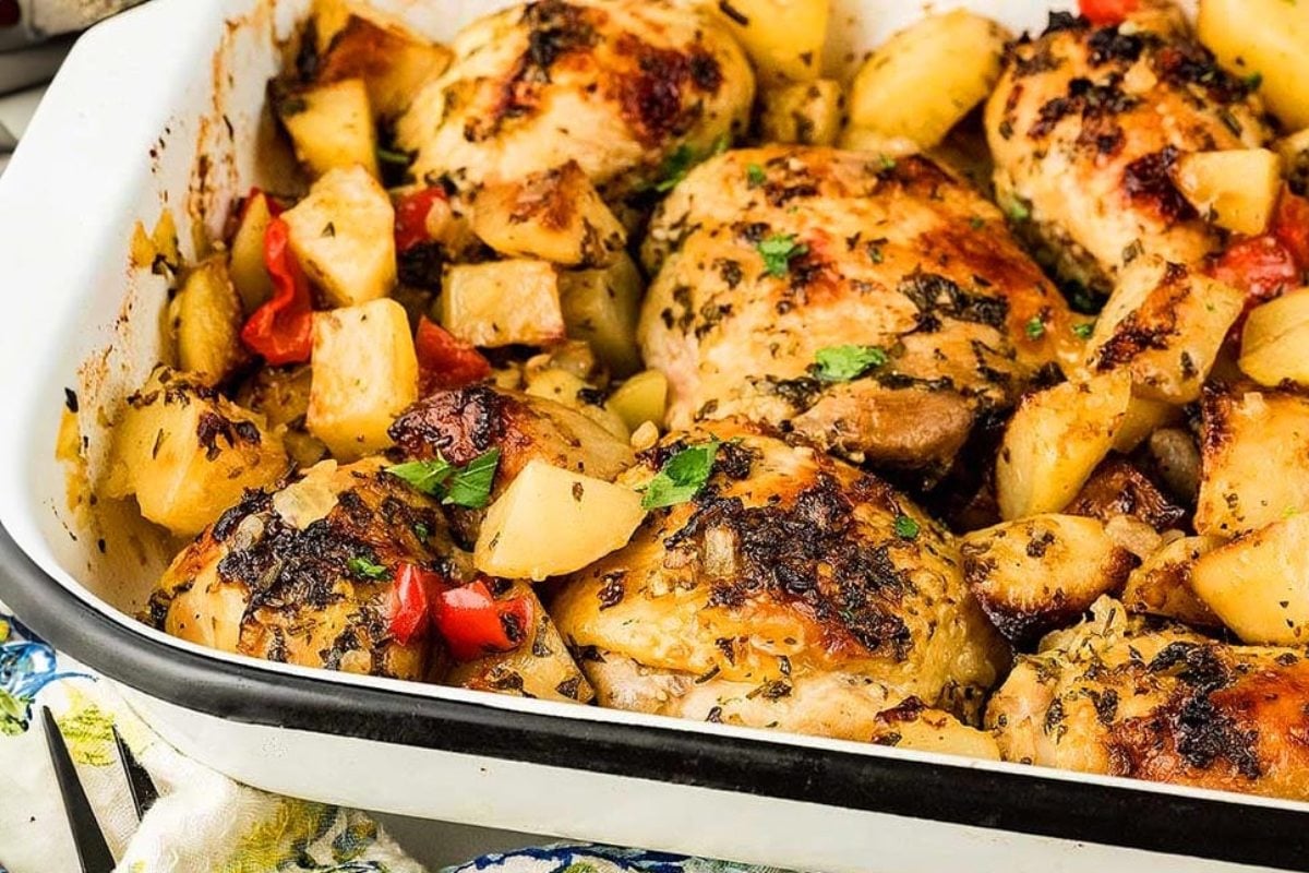 Baked Italian chicken casserole with potatoes and red bell peppers.