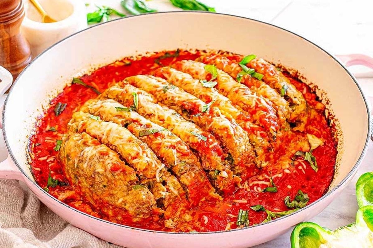 Juicy Italian meatloaf with a thick tomato based sauce and fresh herb garnish.