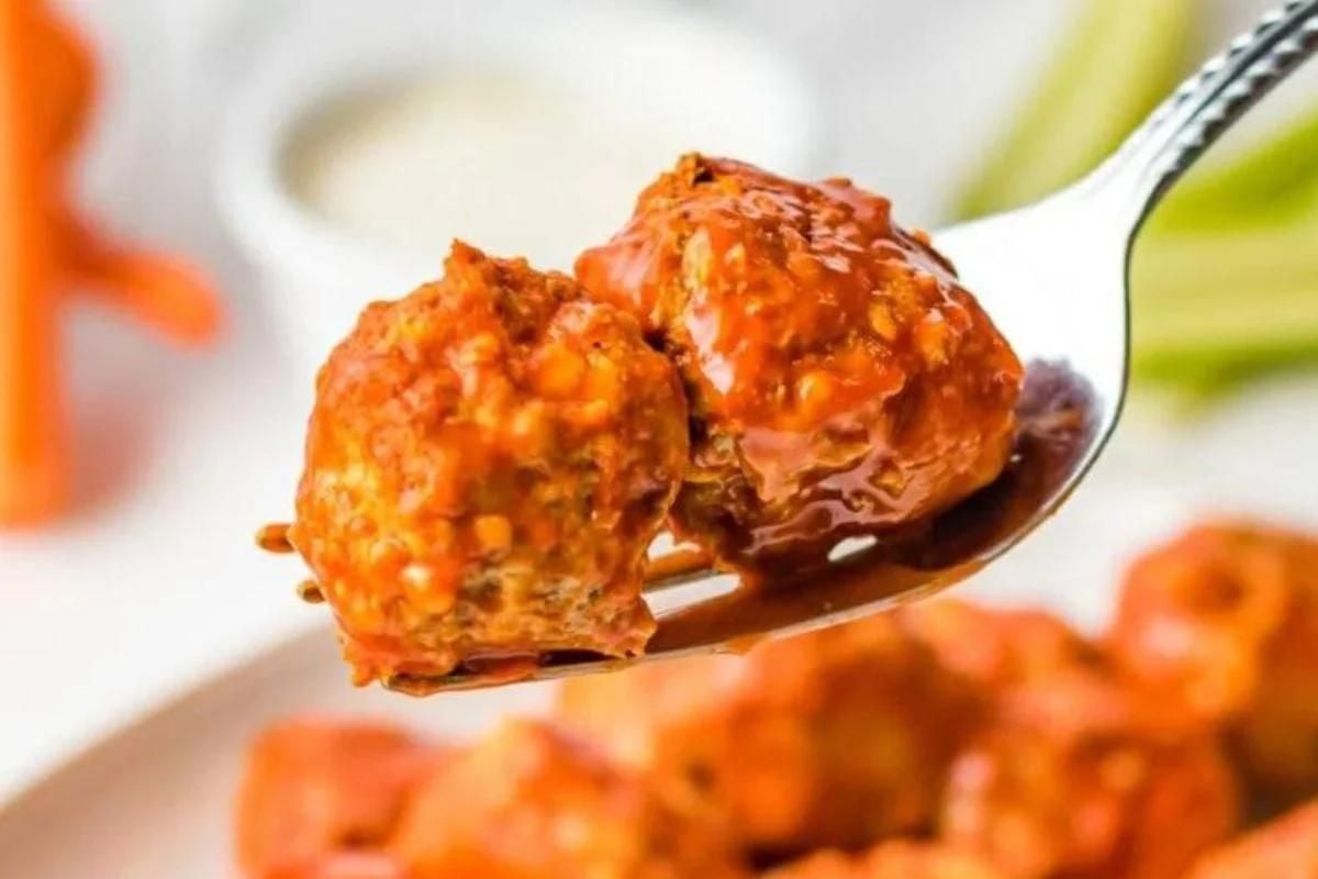 Two Buffalo Chicken Meatballs on a fork.