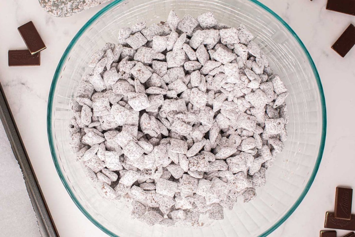 Mint chocolate snack mix known as Muddy Buddies, in a glass serving bowl.