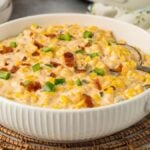 A dish containing a Slow Cooker Cheesy Jalapeno Corn recipe.