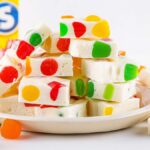 A plate of gumdrop nougat candy embedded with colorful Dots candies.