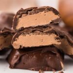 Close-up of homemade 3 Musketeers bites, chocolate-covered candies with a creamy filling, stacked on top of each other.