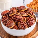 A bowl of 3-ingredient pretzel turtle bites on a rustic wooden board.