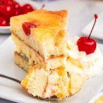 A slice of pineapple upside-down cheesecake rests on a plate. It's just like the one from Cheesecake Factory.